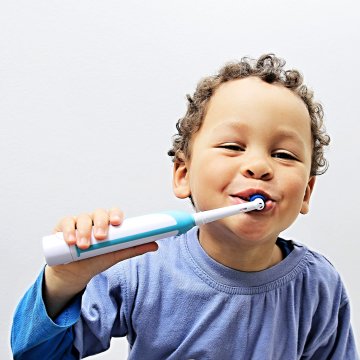 Electric toothbrush being used by a child 